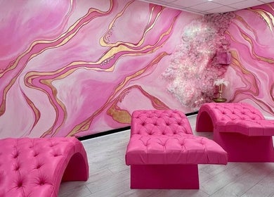 Luxurious pink lounge area at By Beauty Academy, Manchester, England, GB with chic furnishings and vibrant decor.
