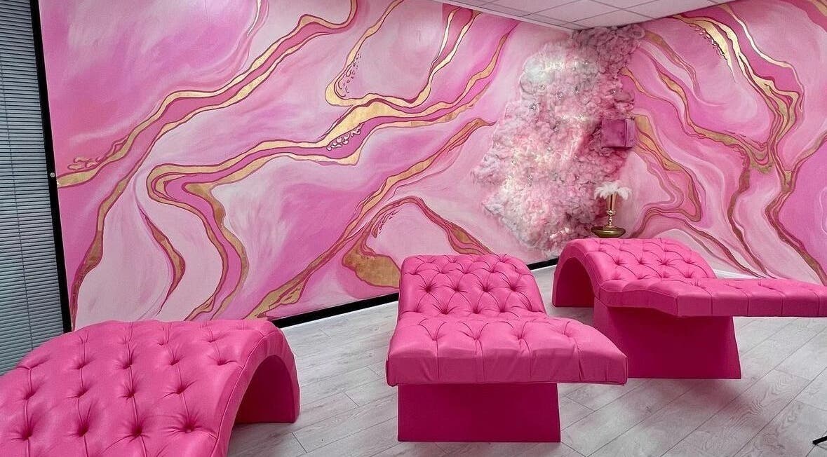 Luxurious pink lounge area at By Beauty Academy, Manchester, England, GB with chic furnishings and vibrant decor.