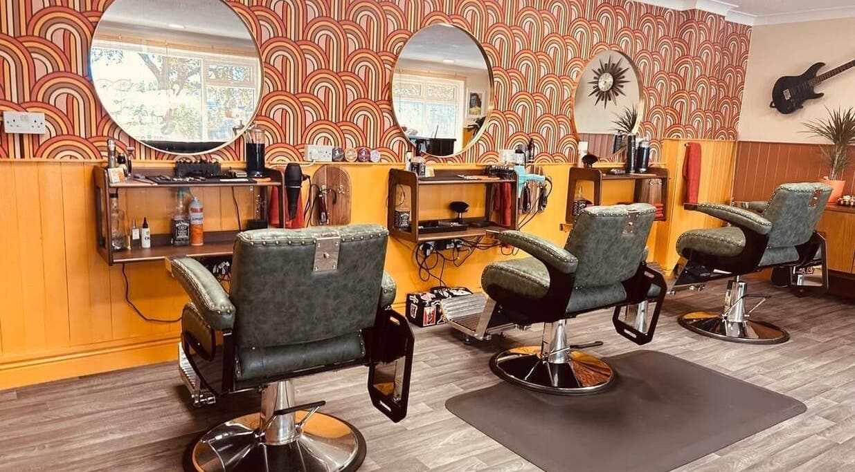 Chay's Barber Shop in Plymouth, England, GB features vintage decor with stylish barber chairs and mirrors.