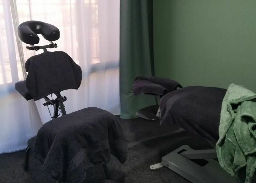 Massage chair and bed at Eucalypt Remedial Massage, Wellard, Western Australia, AU, in a serene green room.