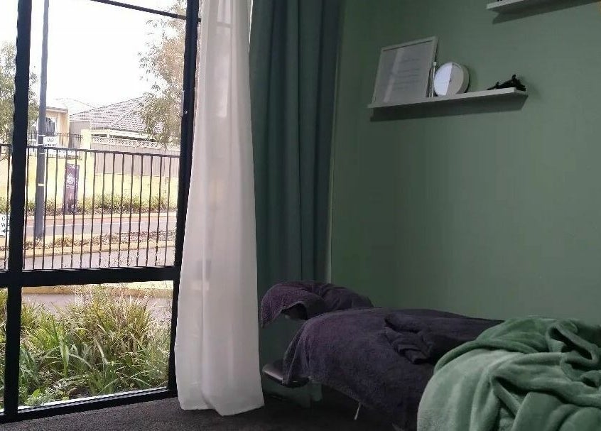 Tranquil massage room at Eucalypt Remedial Massage, Wellard, Western Australia, AU, featuring cozy setup.