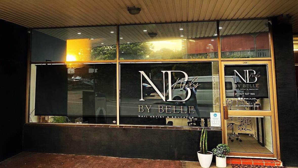 Front view of Nails by Belle with its logo at Budgewoi, NSW, AU, showcasing a stylish glass entrance.
