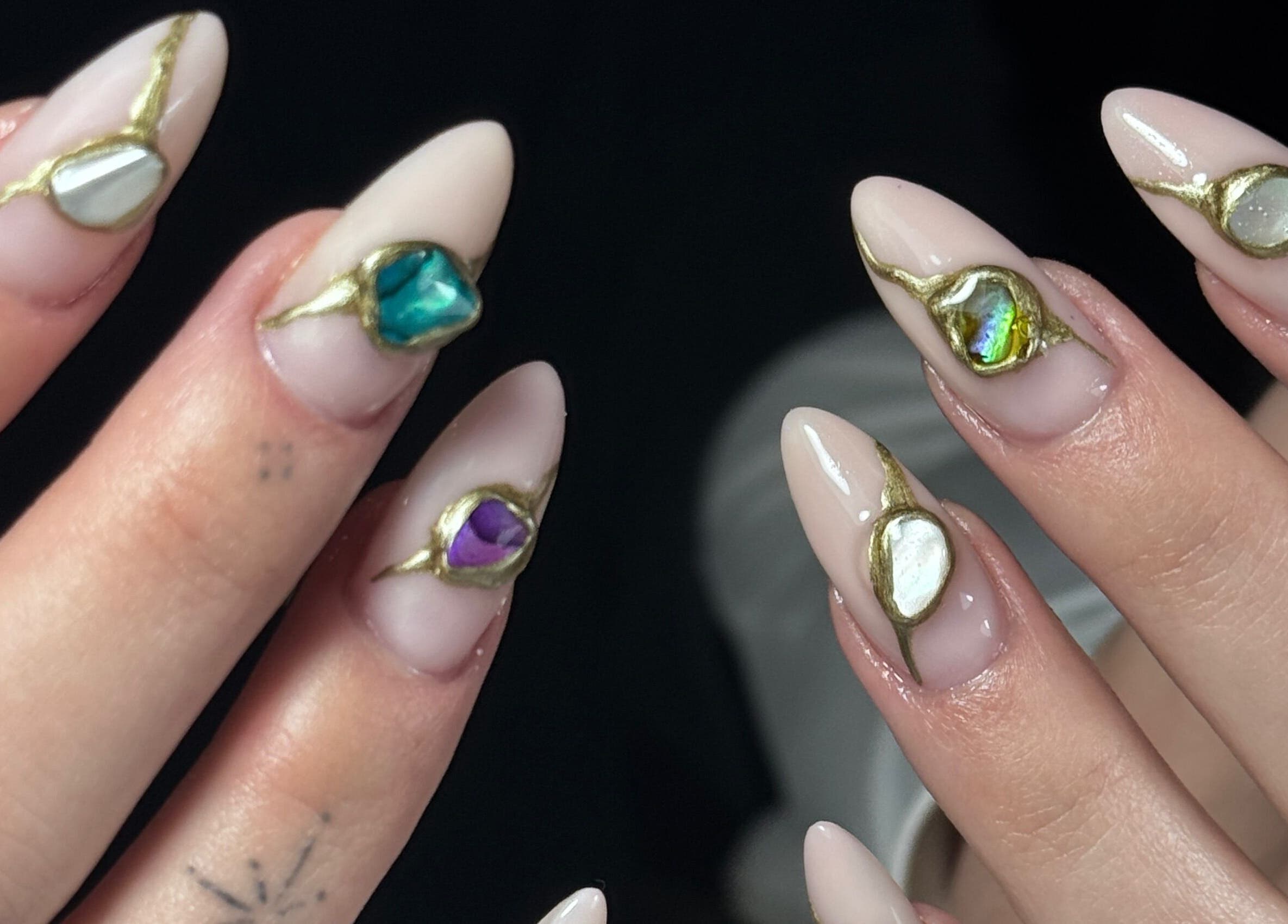 Exquisite gem nail art at Nails by Belle, Budgewoi, NSW, AU, showcasing white and gold designs.