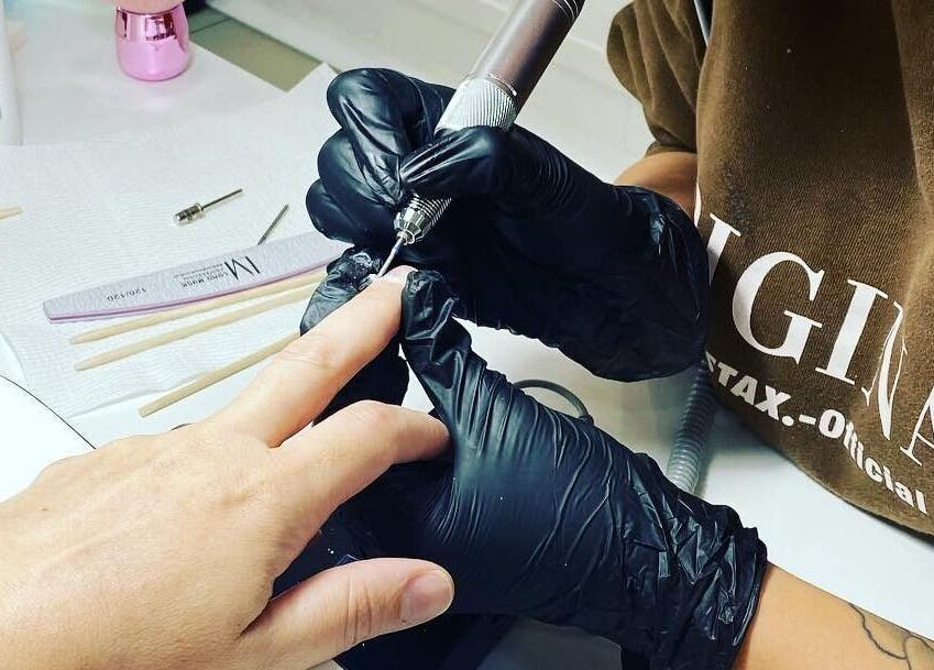 Expert nail technician working at Nails by Belle, Budgewoi, NSW, AU, providing detailed manicures.