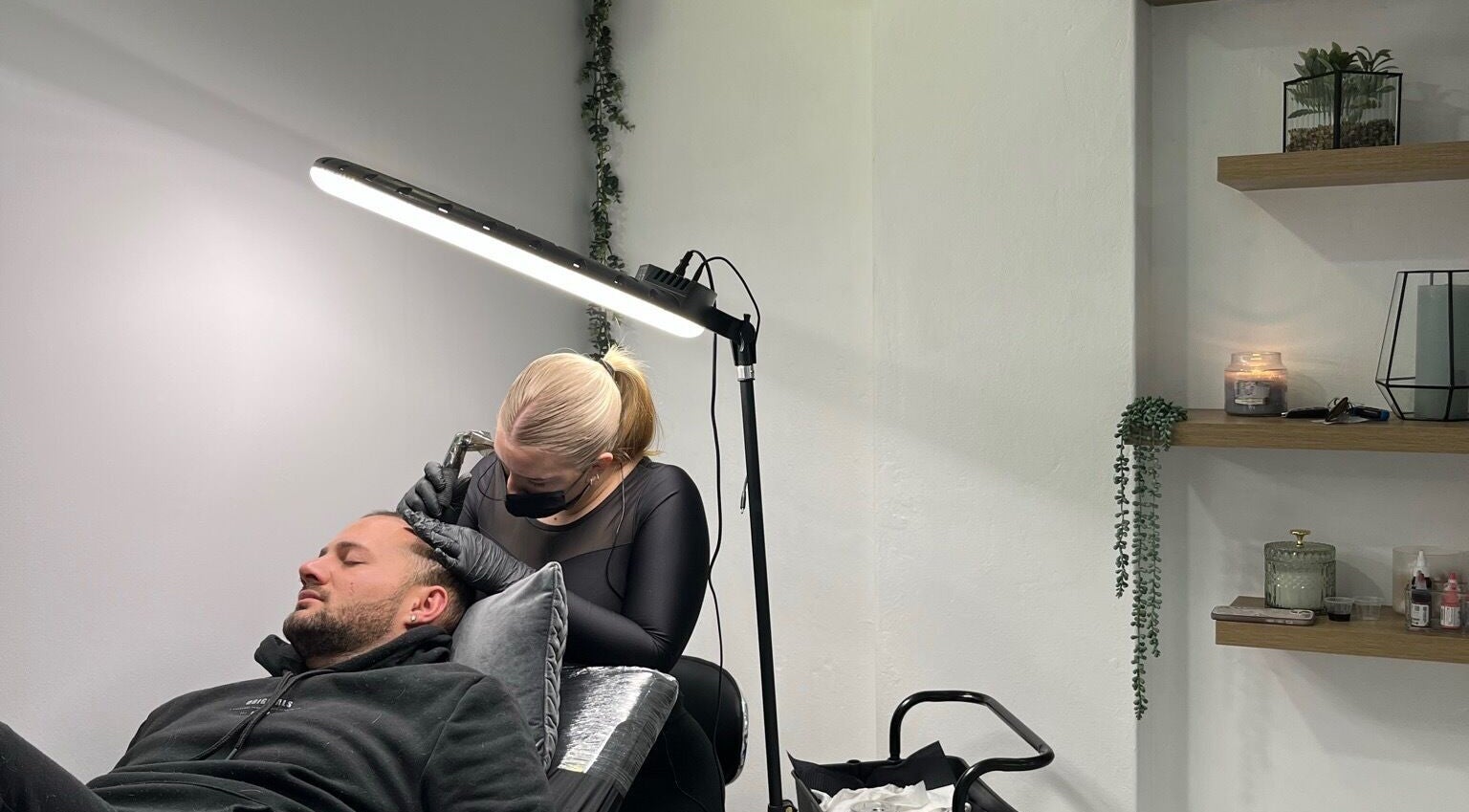 Scalp micropigmentation session at Scalpture Ink, Johannesburg, Gauteng, ZA in a calm, well-lit room.