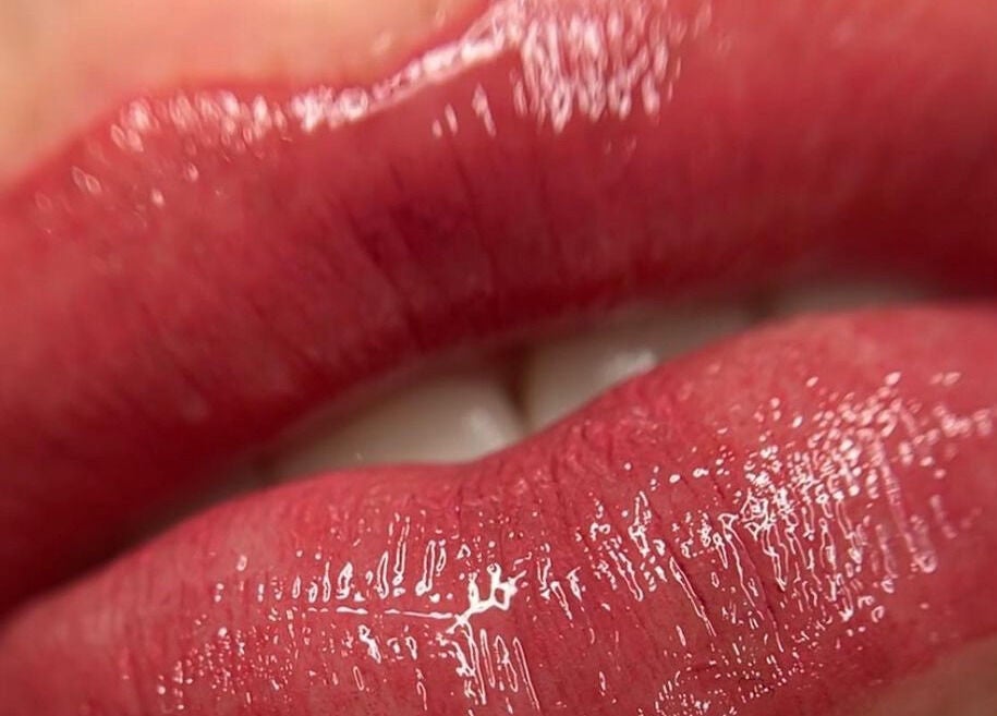 Close-up of glossy red lips showcasing beauty treatment at Scalpture Ink, Johannesburg, Gauteng, ZA.