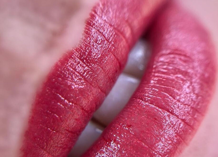 Close-up of vibrant red lips at Scalpture Ink in Johannesburg, Gauteng, ZA, showcasing beauty services.