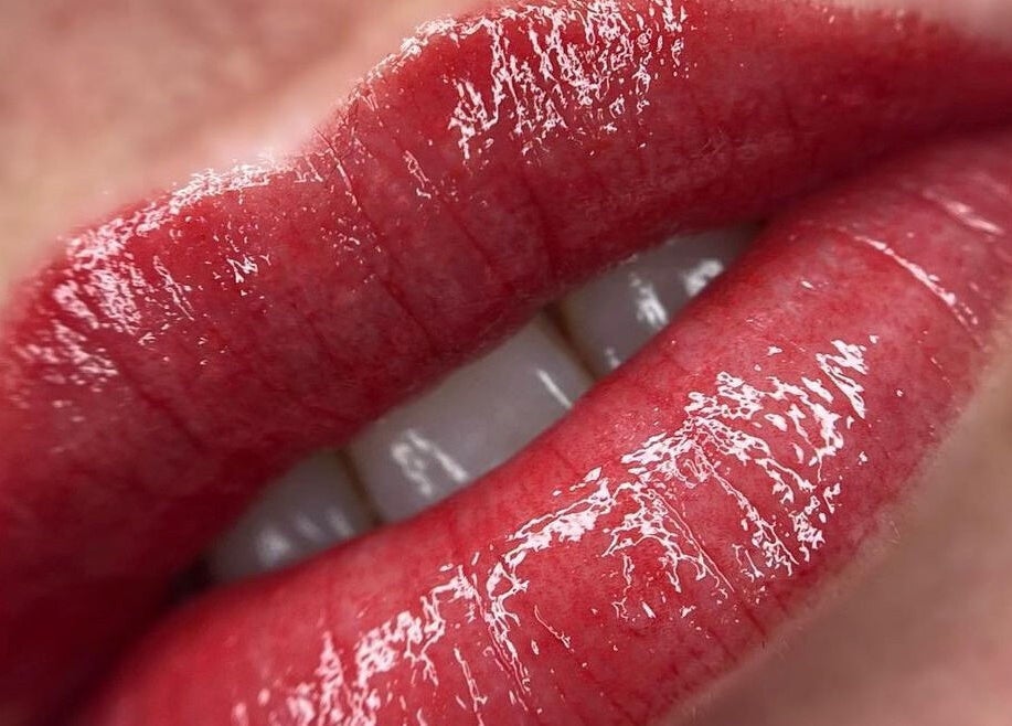 Close-up of glossy red lips at Scalpture Ink, Johannesburg, Gauteng, ZA, showcasing beauty enhancement.
