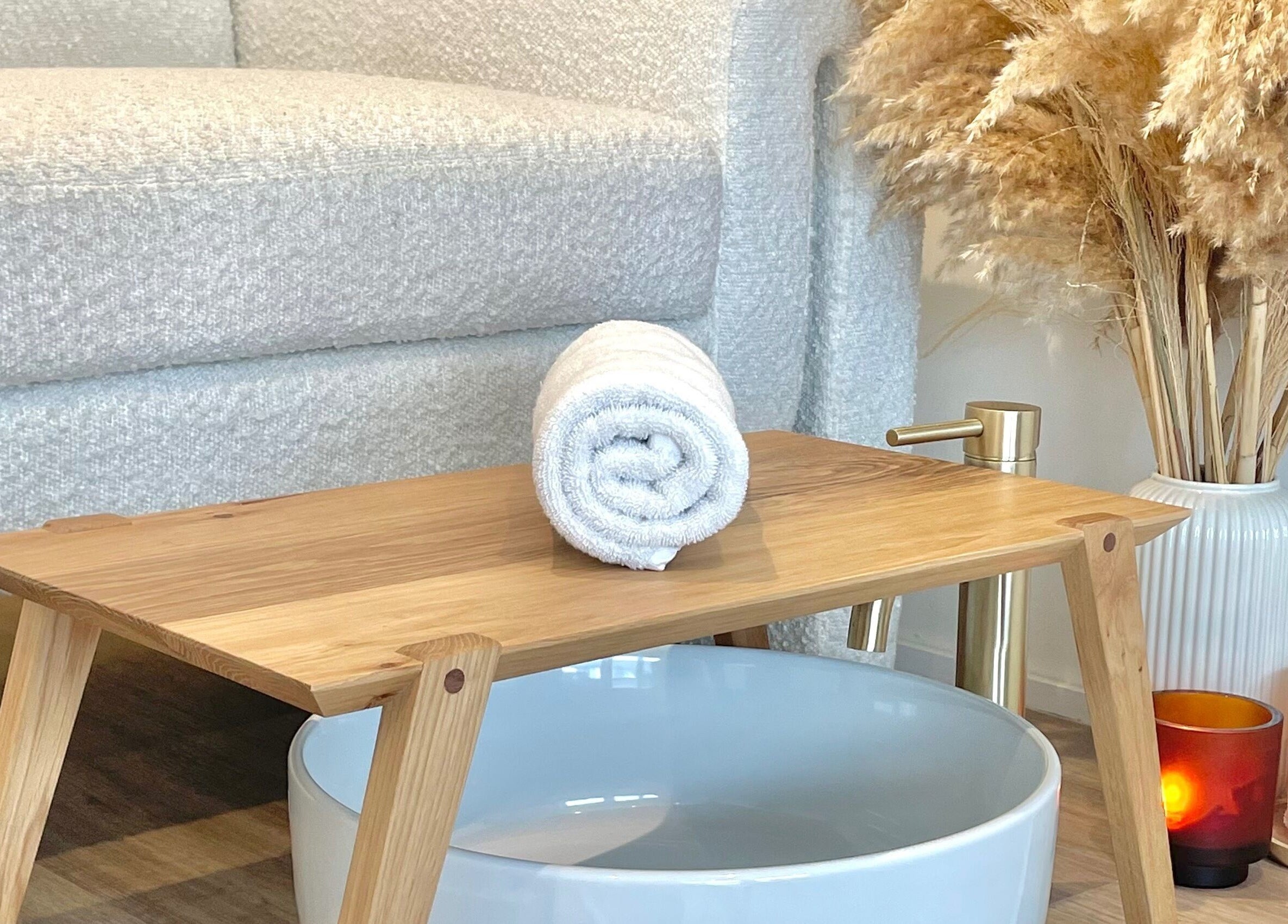 Cozy spa setting at The Beauty Co. Wadebridge, England, GB, featuring a plush towel and elegant decor.