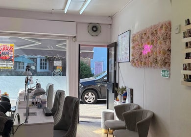 Interior of Kaites Nails, Twickenham, England with elegant chairs and nail polish display.