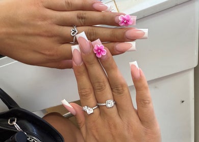 Exquisite floral nail art at Kaites Nails, Twickenham, England, GB. Perfectly crafted pink blossoms on manicured hands.