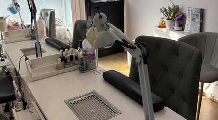 Modern manicure station at Kaites Nails, Twickenham, England, GB, with cozy chairs and nail care products.