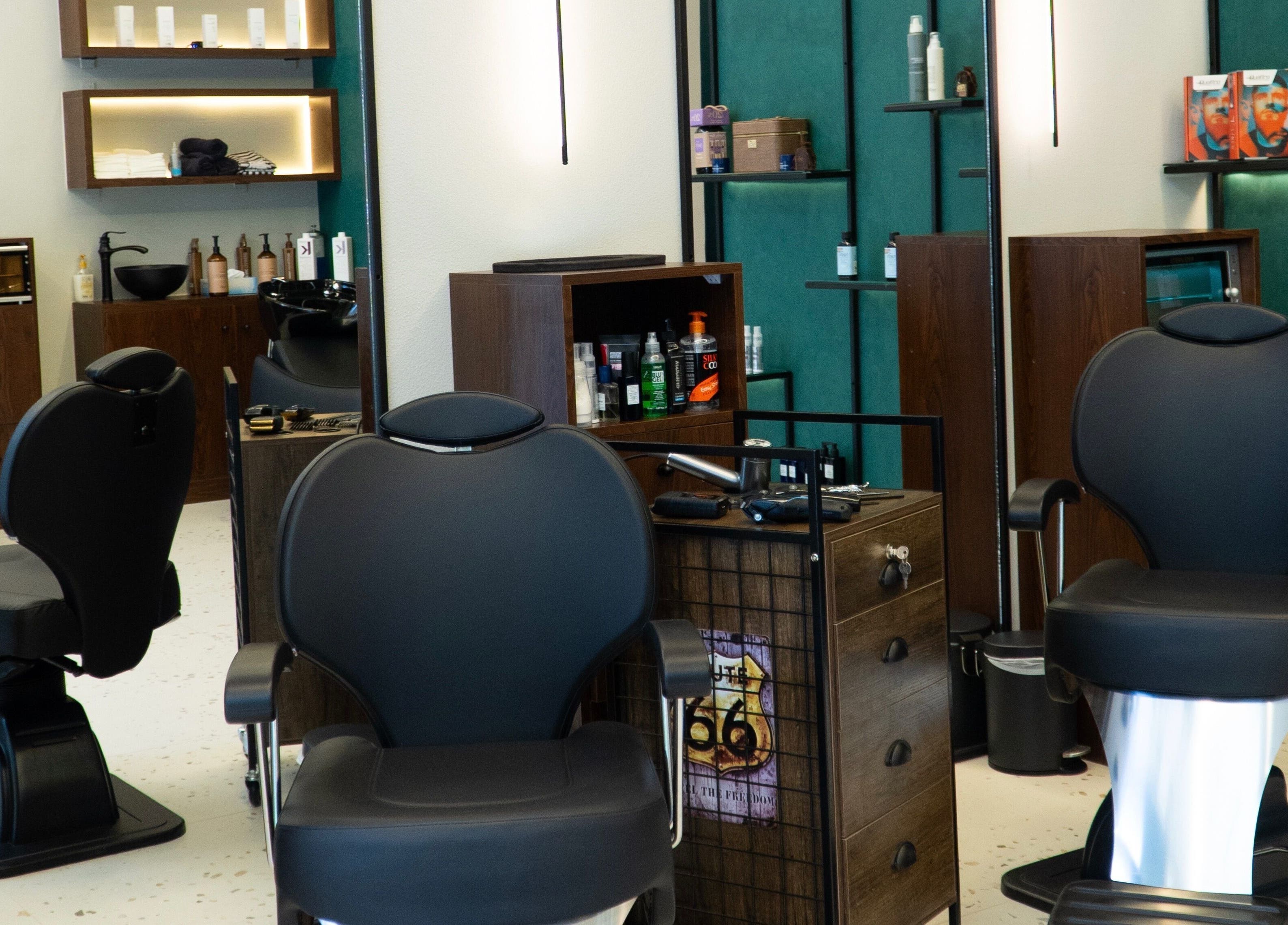 Sleek interior of 717 Gents Salon | Dubai Hills in Dubai, Dubai, AE showcasing modern barber chairs and stylish decor.