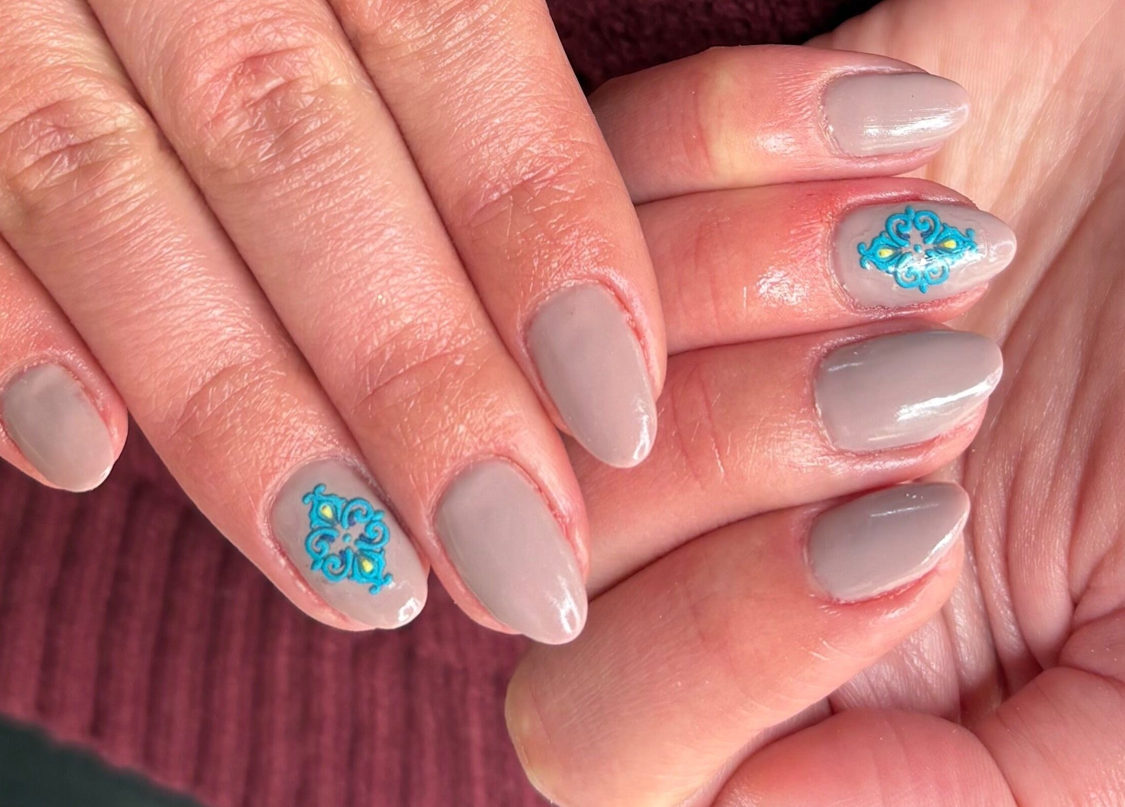 Elegant beige nails with blue floral art at Kim’s Beauty Center, Iż-żurrieq, MT.