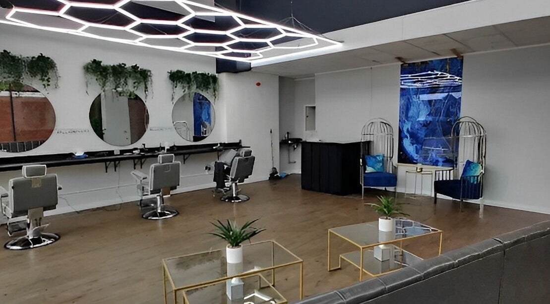 Stylish interior of Billionhairs Barbershop in Trowbridge, England, GB with modern chairs and elegant decor.