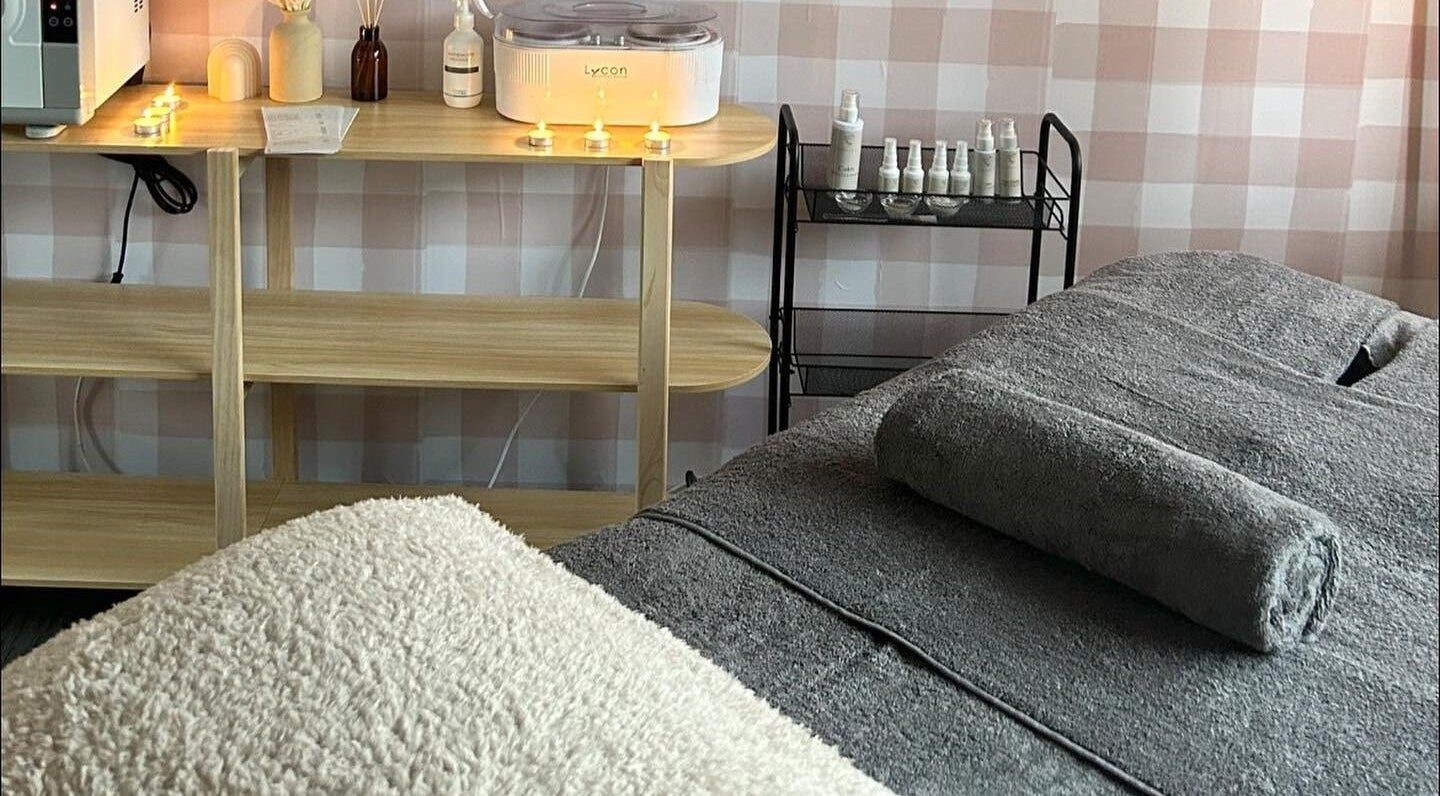 Relaxing treatment room at Sundara Beauty in Jubilee Pocket, Queensland, AU, with candles and cozy setup.