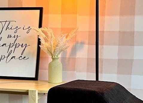 A serene corner at Sundara Beauty, Jubilee Pocket, Queensland, AU, with decor that reads 'This is my happy place'.