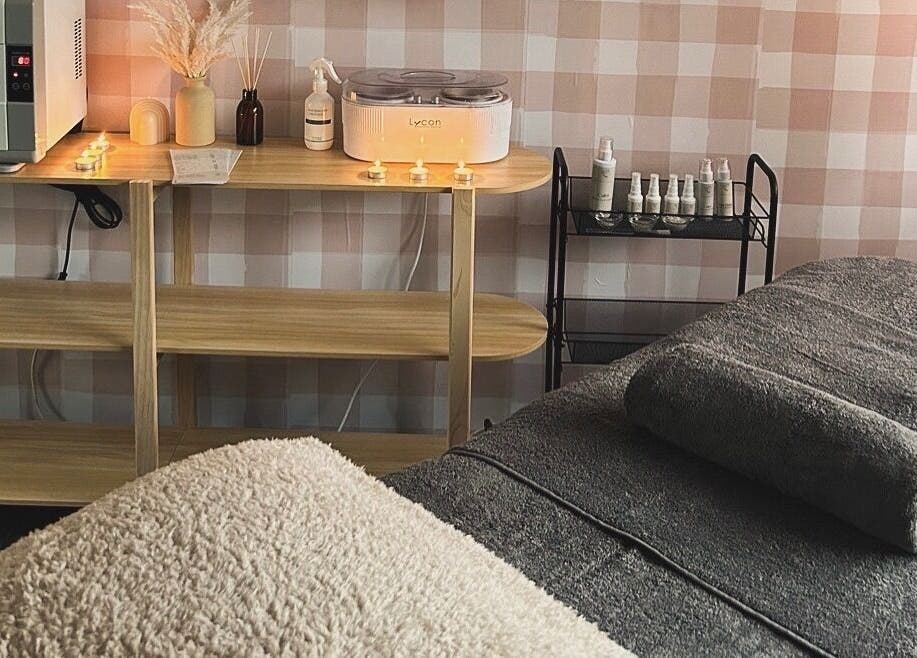 Cozy spa room at Sundara Beauty, Jubilee Pocket, Queensland, AU, featuring a massage table and warm lighting.