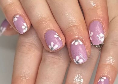 Floral lavender nail art at HCM Nails in Falmouth, England, GB. Perfect for beauty enthusiasts.