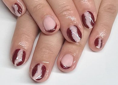 Stylish maroon nail art with stripes at HCM Nails, Falmouth, England, GB.