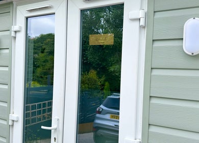 Entrance of HCM Nails with sleek glass doors in Falmouth, England, GB.