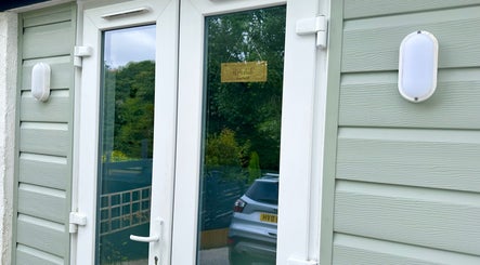 Entrance of HCM Nails with sleek glass doors in Falmouth, England, GB.