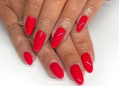 Vibrant red manicure at HCM Nails, Falmouth, England, GB, showcasing perfect polish finish.