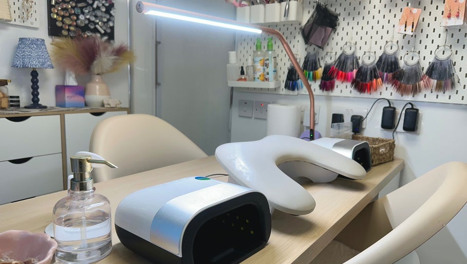Modern nail studio setup at HCM Nails, Falmouth, England, GB, showcasing tools and vibrant decor.