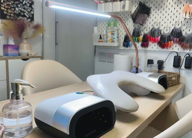 Modern nail studio setup at HCM Nails, Falmouth, England, GB, showcasing tools and vibrant decor.