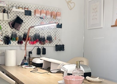 Cozy nail station at HCM Nails, Falmouth, England, GB featuring nail polish samples, tools, and decor.