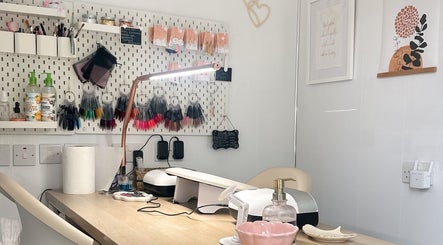 Cozy nail station at HCM Nails, Falmouth, England, GB featuring nail polish samples, tools, and decor.