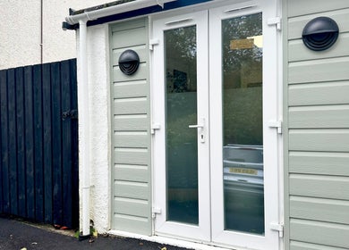 Stylish entrance of Hannah Morant Nails in Falmouth, England, GB with elegant white doors and modern lamps.