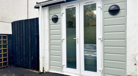 Stylish entrance of Hannah Morant Nails in Falmouth, England, GB with elegant white doors and modern lamps.