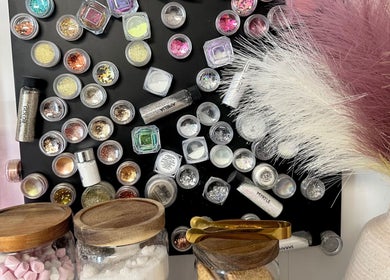 Colorful glitter and powders at Hannah Morant Nails, Falmouth, England, GB showcasing nail art options.