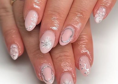 Elegant nail art at Hannah Morant Nails in Falmouth, England, GB features silver glitter on pink polish.