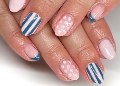 Stylish pastel nail art by Hannah Morant Nails, Falmouth, England, GB showcasing striped and dotted designs.