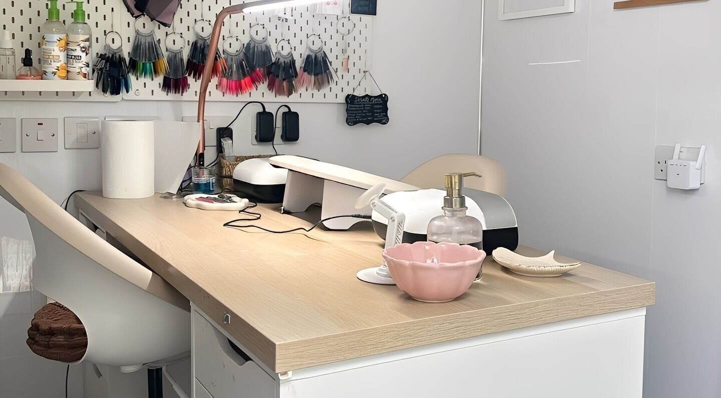 Modern nail station at Nails by Hannah Morant, Falmouth, England, GB, showcasing tools and decorations.
