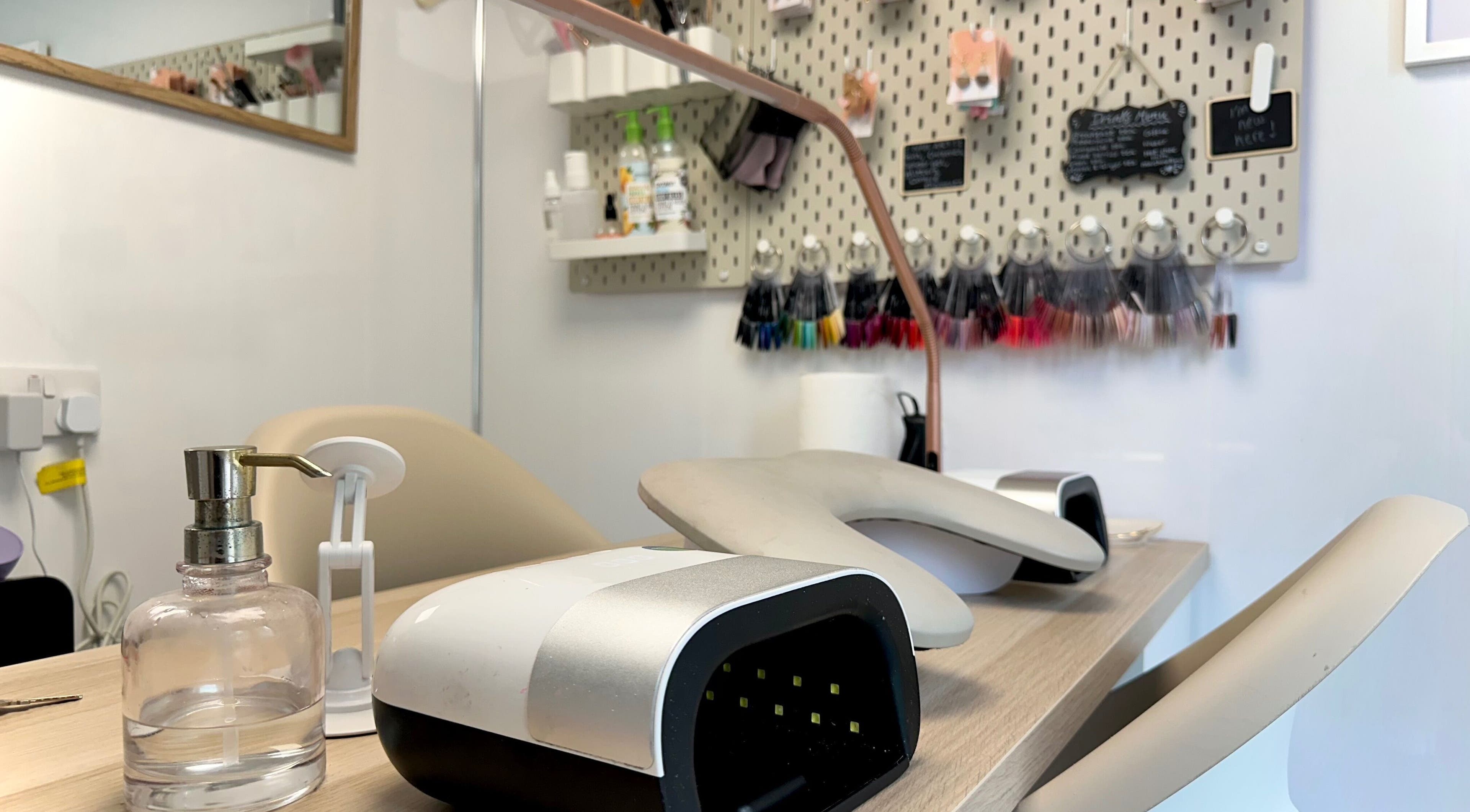 Elegant nail station at Nails by Hannah Morant, Falmouth, England, GB with modern tools and polish samples.