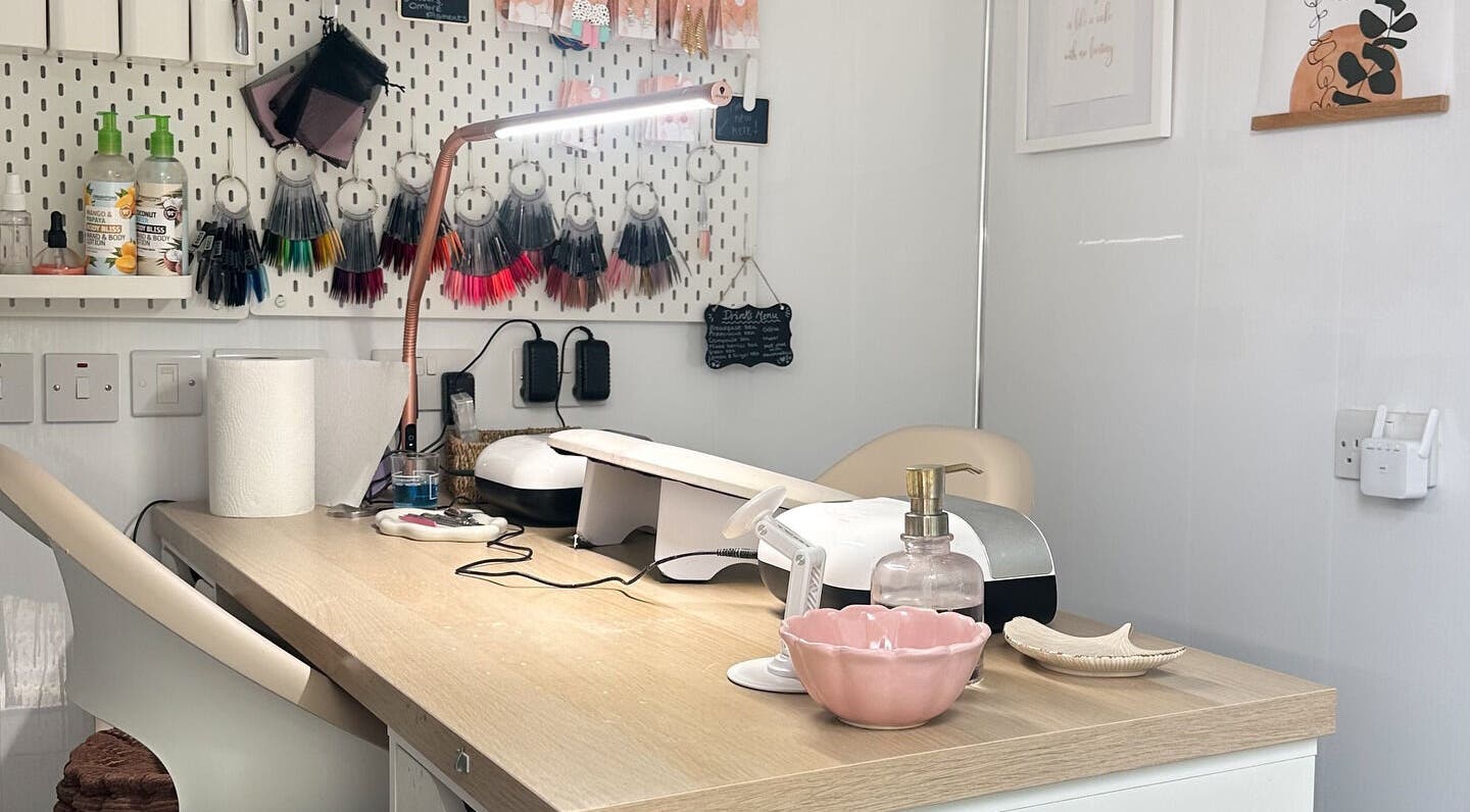 Stylish nail station at Nails by Hannah Morant, Falmouth, England, GB, featuring tools and colorful samples.