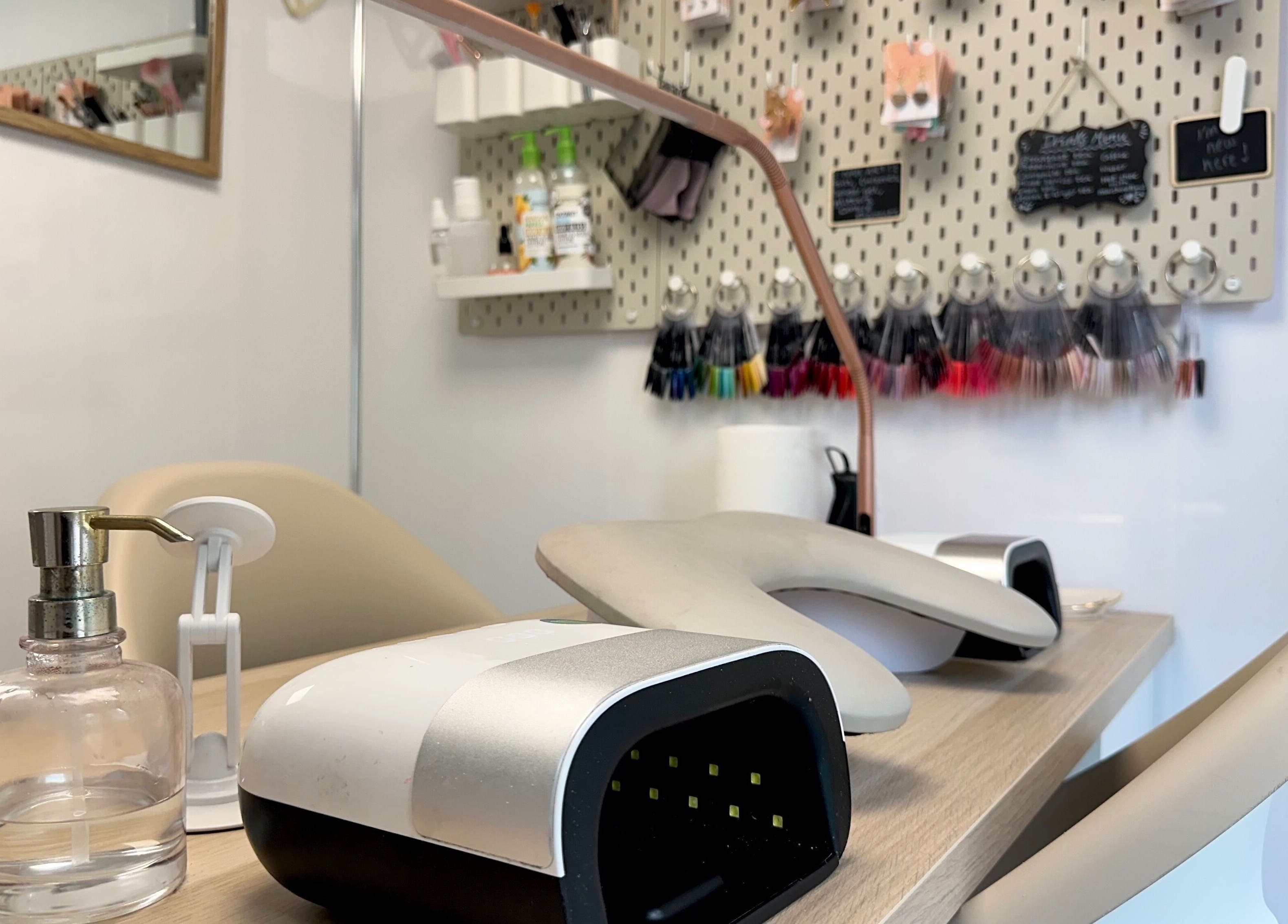 Modern nail station at Nails by Hannah Morant, Falmouth, England, GB with tools and polishes on display.