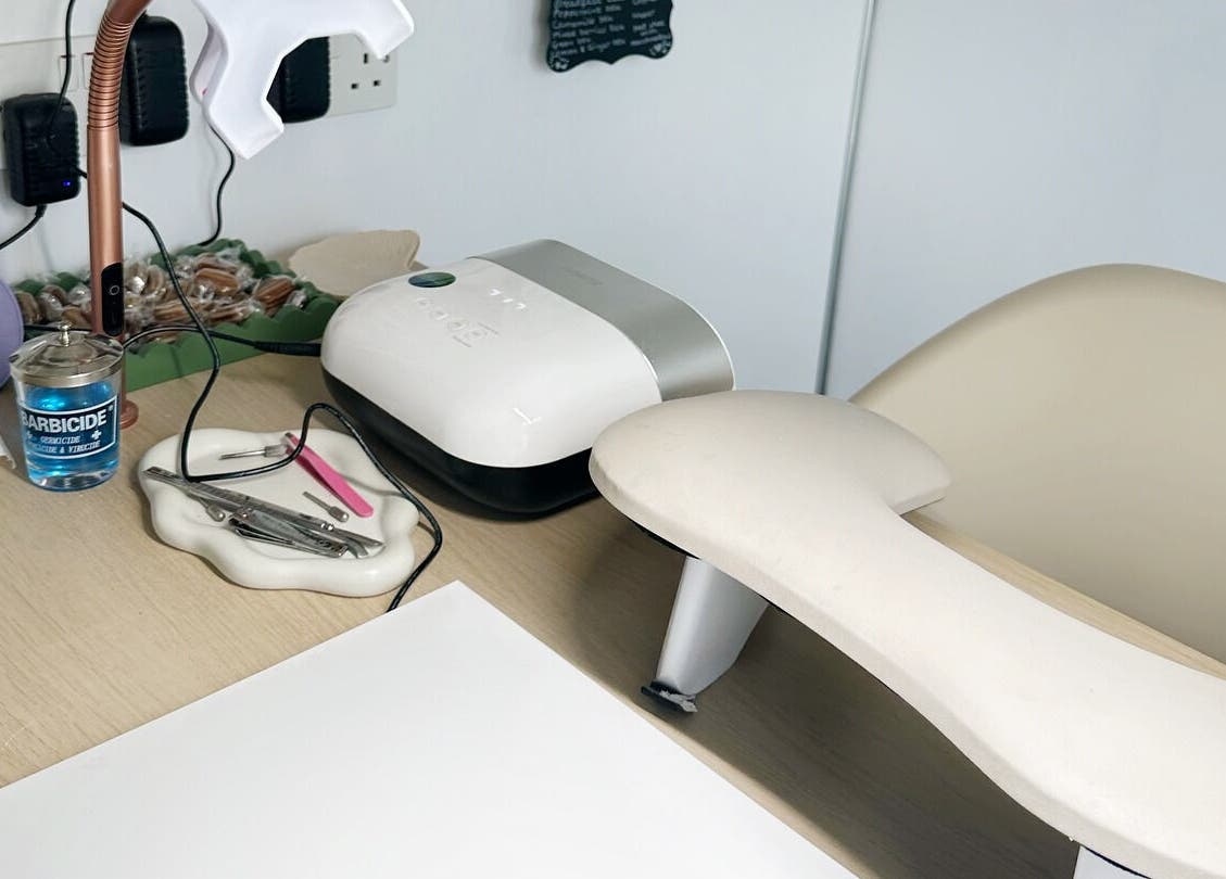 Manicure station at Nails by Hannah Morant, Falmouth, England, GB, featuring tools and LED lamp.