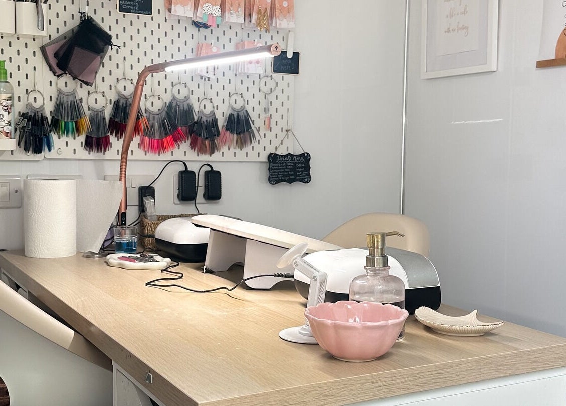 Cozy nail workstation at Nails by Hannah Morant in Falmouth, England, GB, showcasing tools and color samples.
