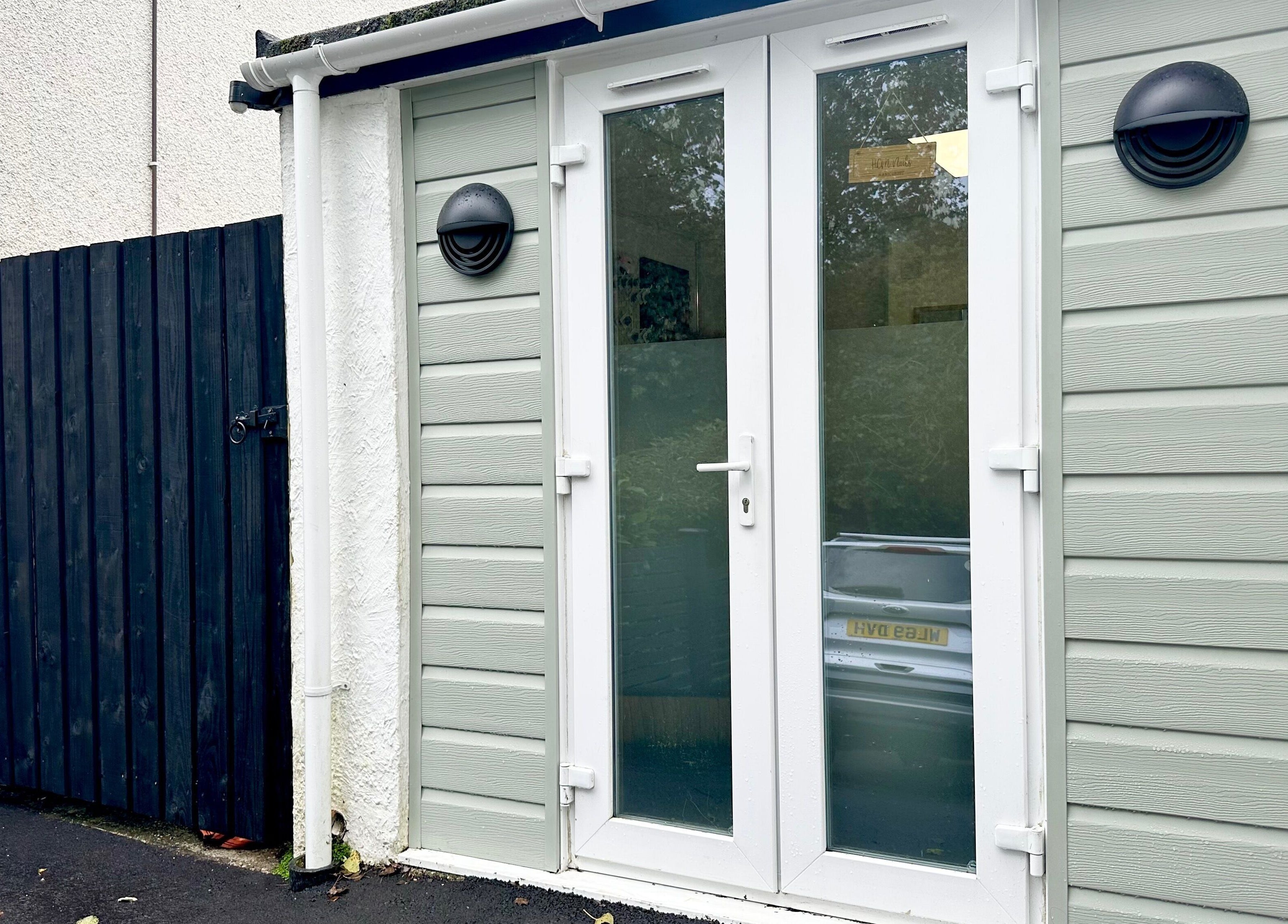 Entrance to Nails by Hannah Morant in Falmouth, England, GB, featuring stylish glass doors.