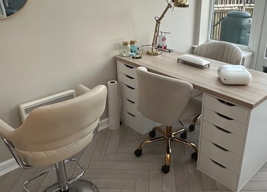 Modern nail station at GB Hair & Beauty in Cowplain, England, GB, featuring chic chairs and elegant decor.