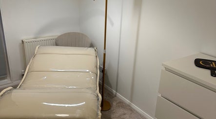 Peaceful treatment room at GB Hair & Beauty, Cowplain, England, GB, featuring cozy bed and elegant decor.