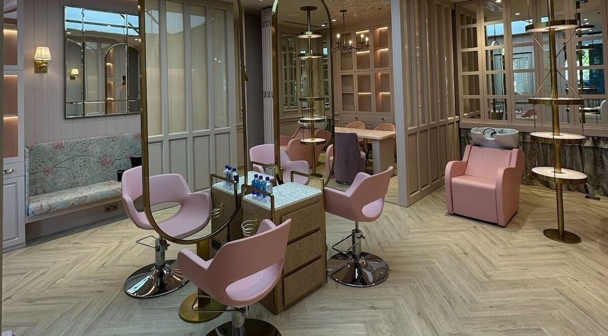 Modern interior of Clips and Flicks Ladies Beauty Salon, Dubai, Dubai, AE with chic pink seating and mirrors.