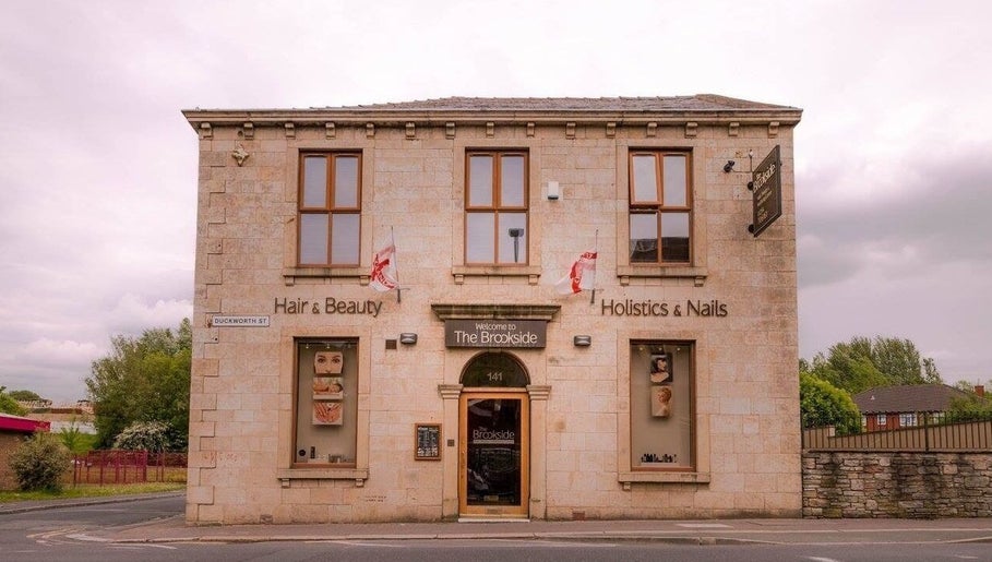 Entrance of The Brookside Hair, Barber & Beauty Salon in Darwen, England, GB with inviting signage.