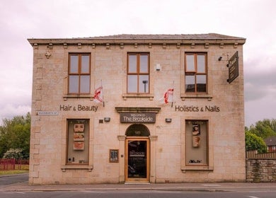 Entrance of The Brookside Hair, Barber & Beauty Salon in Darwen, England, GB with inviting signage.