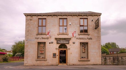 Entrance of The Brookside Hair, Barber & Beauty Salon in Darwen, England, GB with inviting signage.