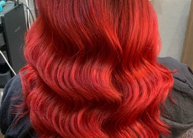 Vibrant red wavy hair styled at The Brookside Hair, Barber & Beauty Salon, Darwen, England, GB.